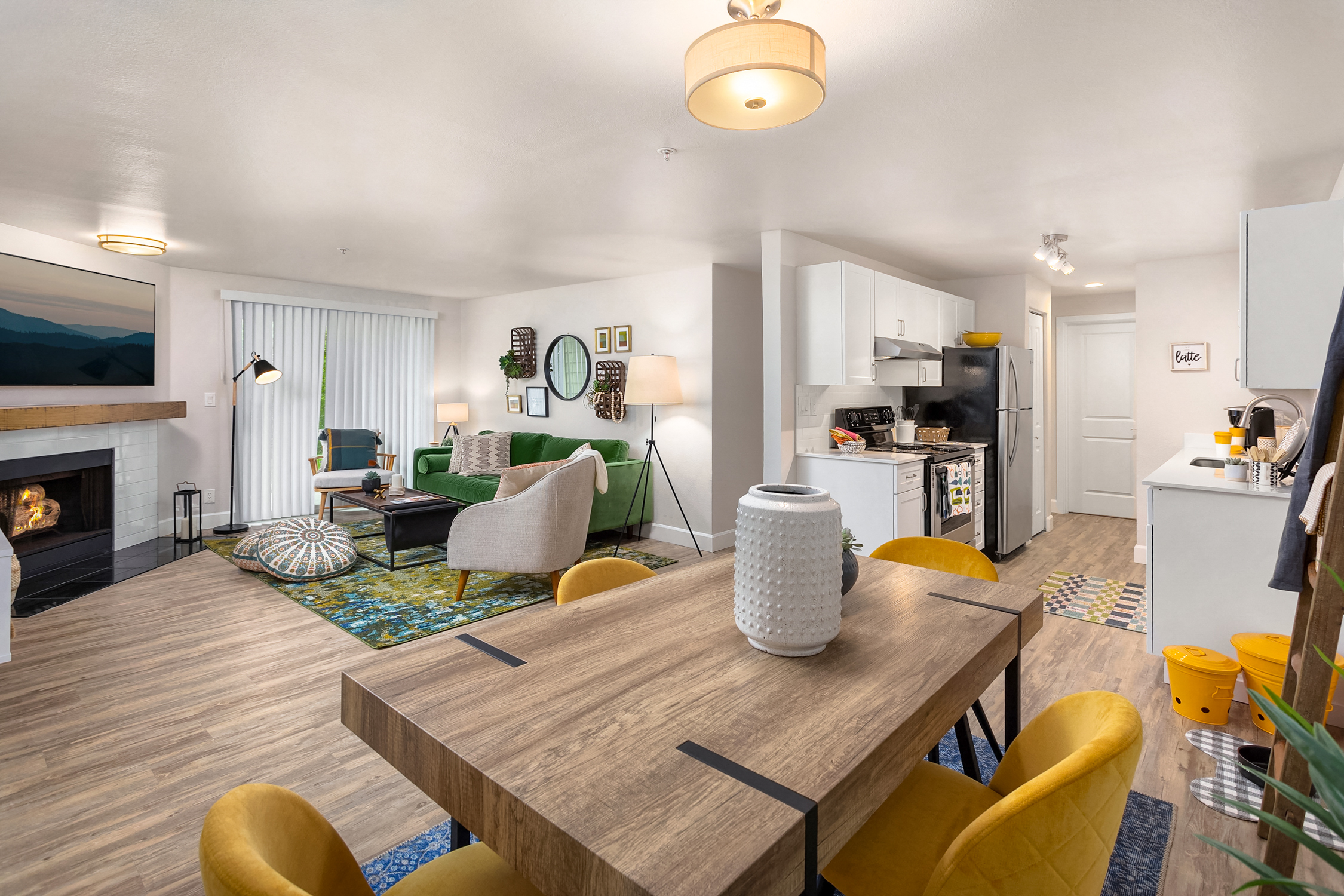 a living room and dining room with a table and chairs