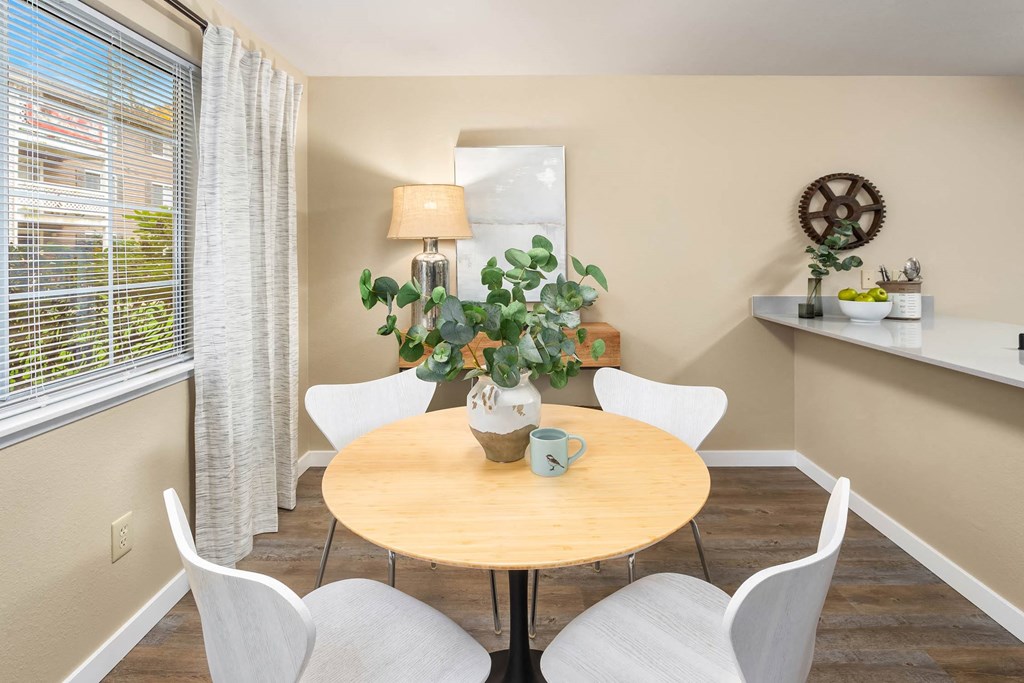 a dining room with a table and chairs and a window