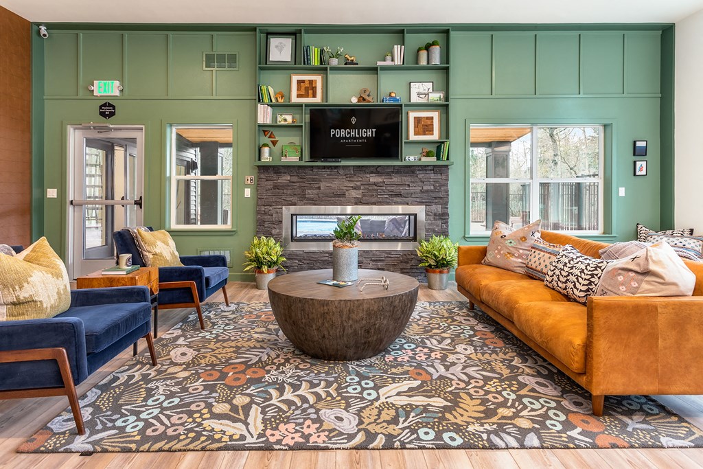 a living room with green walls and a fire place