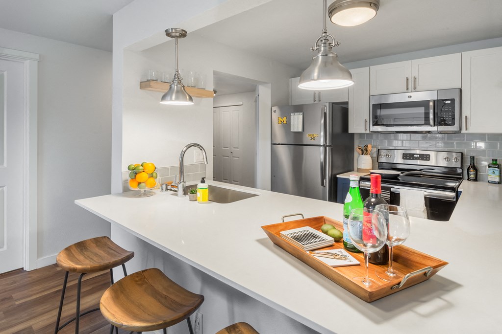 The kitchens feature stainless steel appliances.