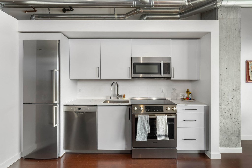 a kitchen with stainless steel appliances and white cabinets