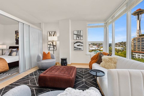 a living room with a white couch and a view of the city