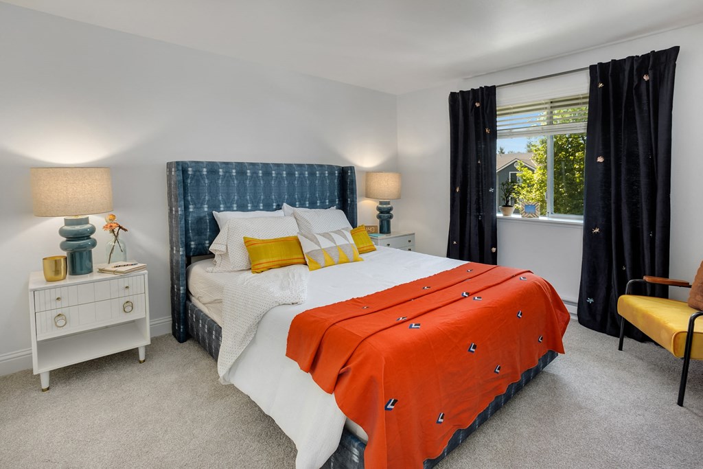 a bedroom with a bed and a window