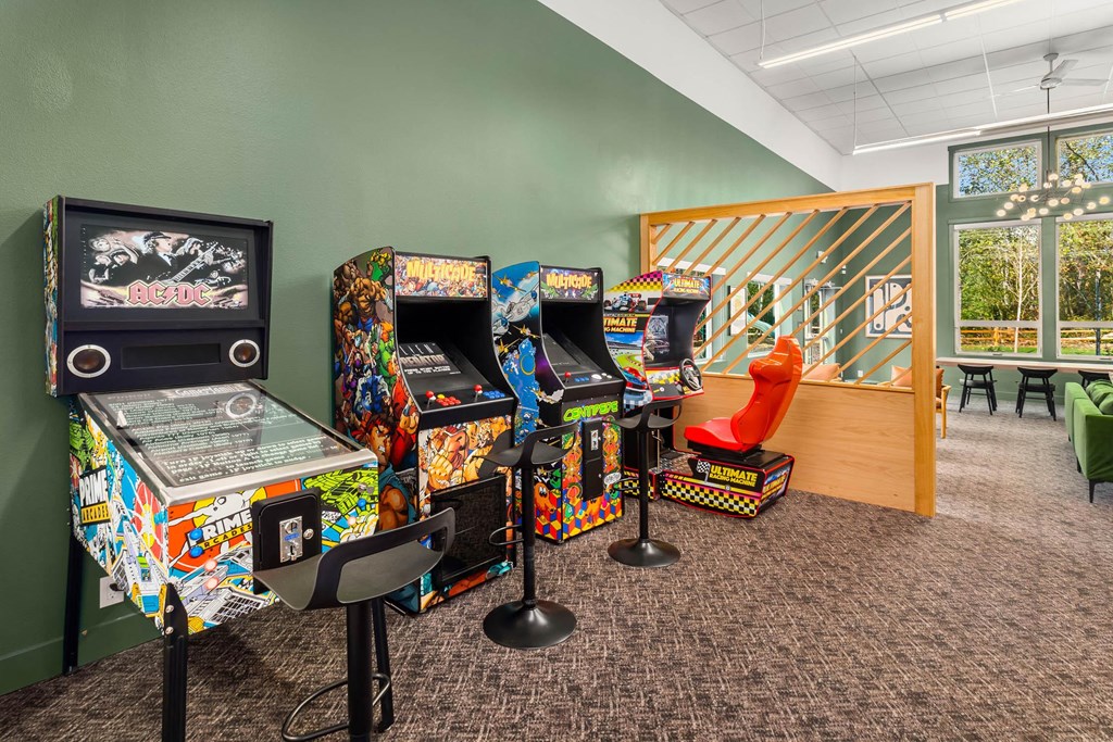 a room filled with arcade games and a red chair