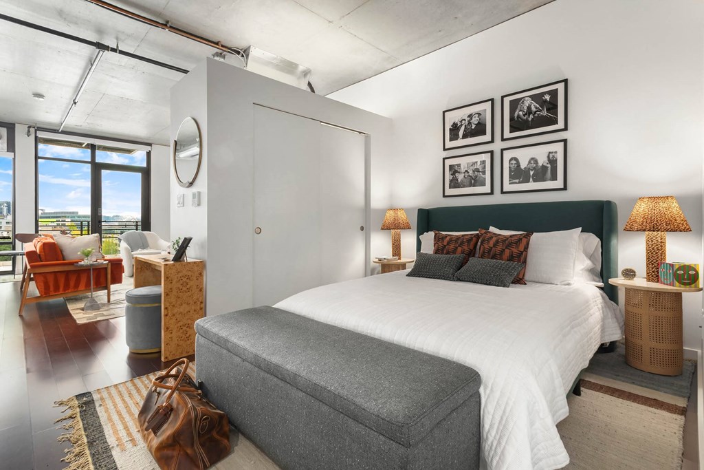 a bedroom with a bed and a large window