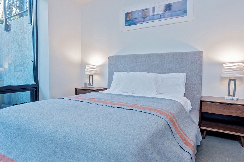 a bedroom with a bed and a window