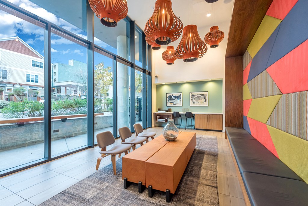 a living room with large windows and a table and chairs