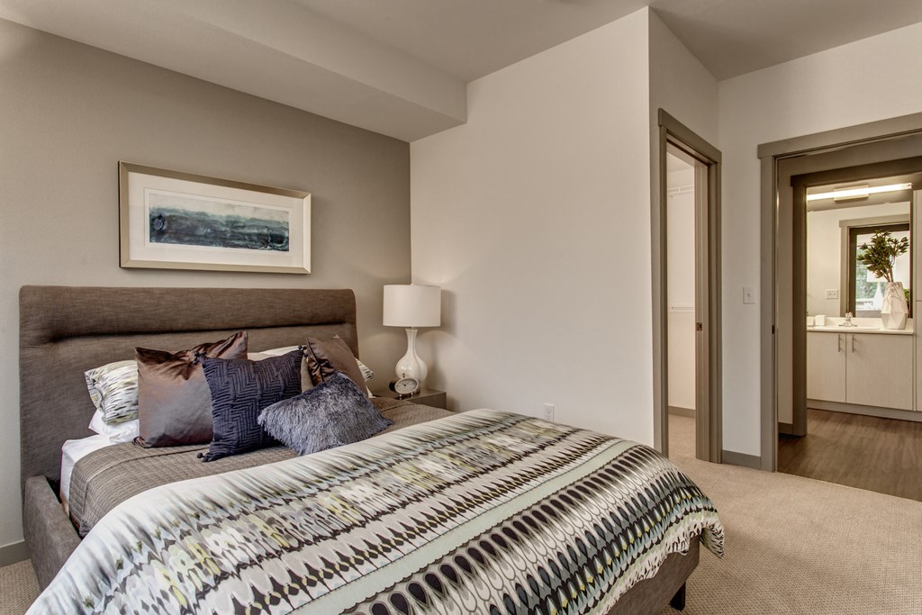 a bedroom with a bed and a mirror in a house