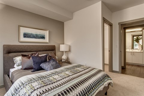 a bedroom with a bed and a mirror in a house