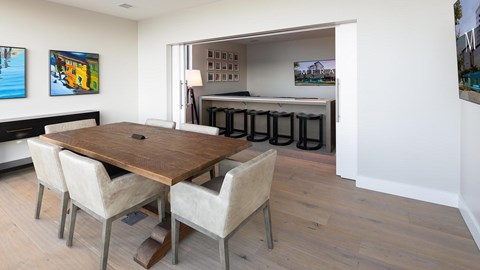 A dining room with a wooden table and chairs.