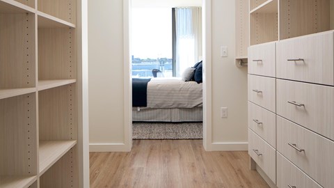 A bedroom with a bed and a window.