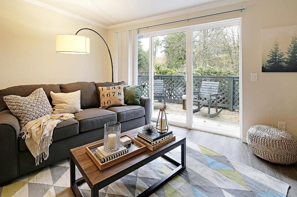 a living room with a couch and a coffee table and a sliding glass door