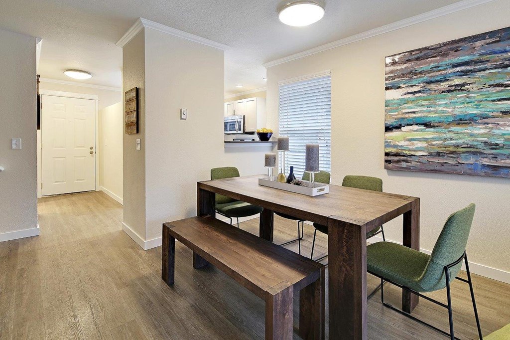 a dining room with a table and chairs