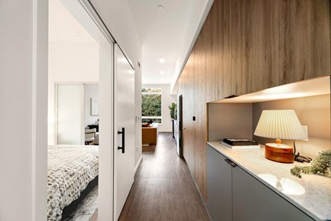 a bedroom with a bed and a counter with a lamp