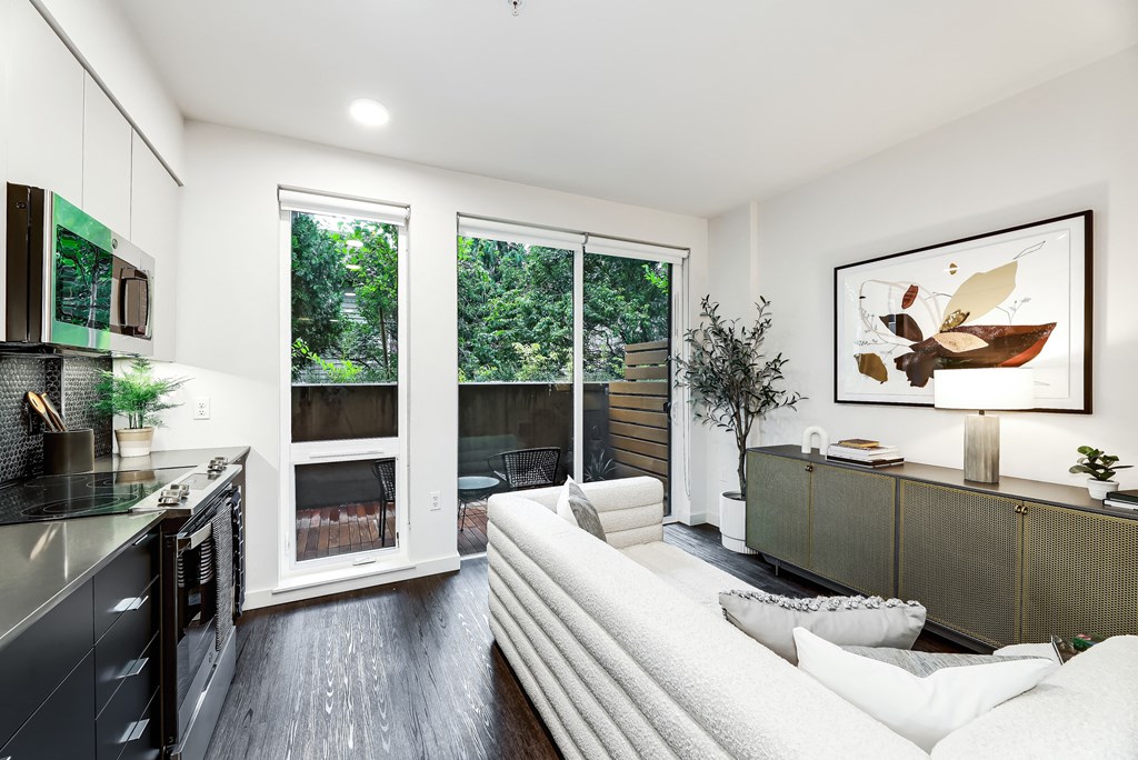 a living room with a white couch and a large window