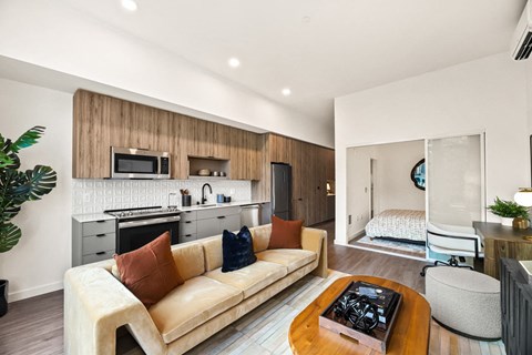 a living room with a couch and a kitchen