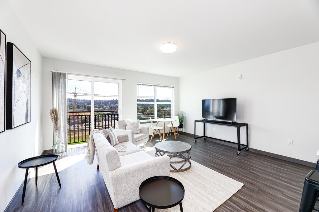 a living room with a couch and a chair and a television