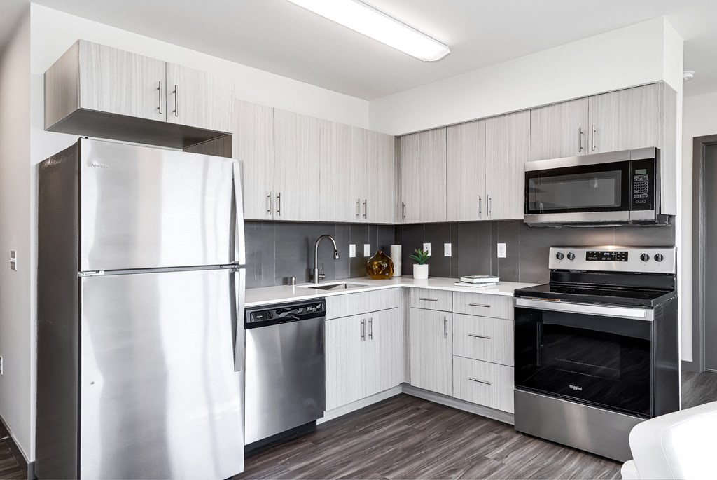 a kitchen with stainless steel appliances and white cabinets