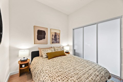 a bedroom with a large bed and a window