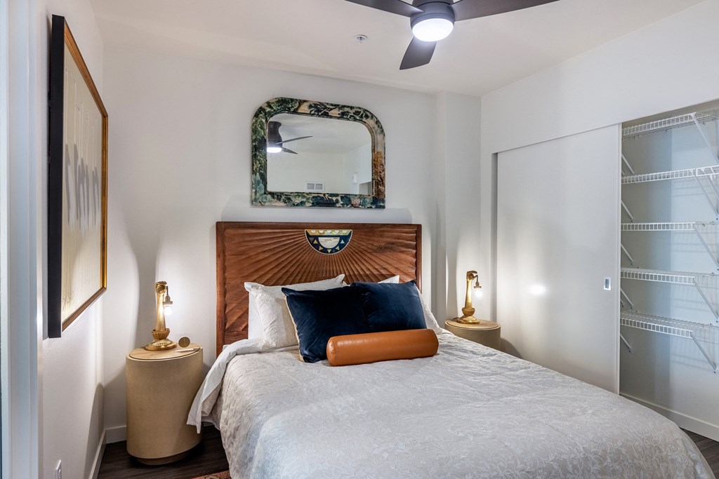 a bedroom with a large bed and a mirror