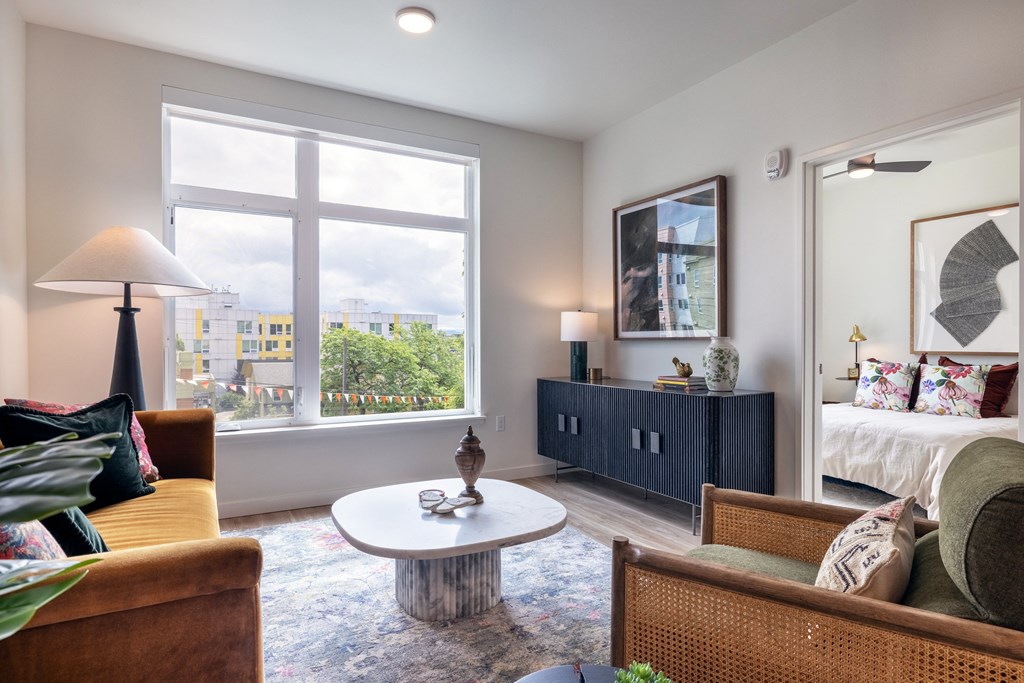 a living room with a large window and a couch and a table