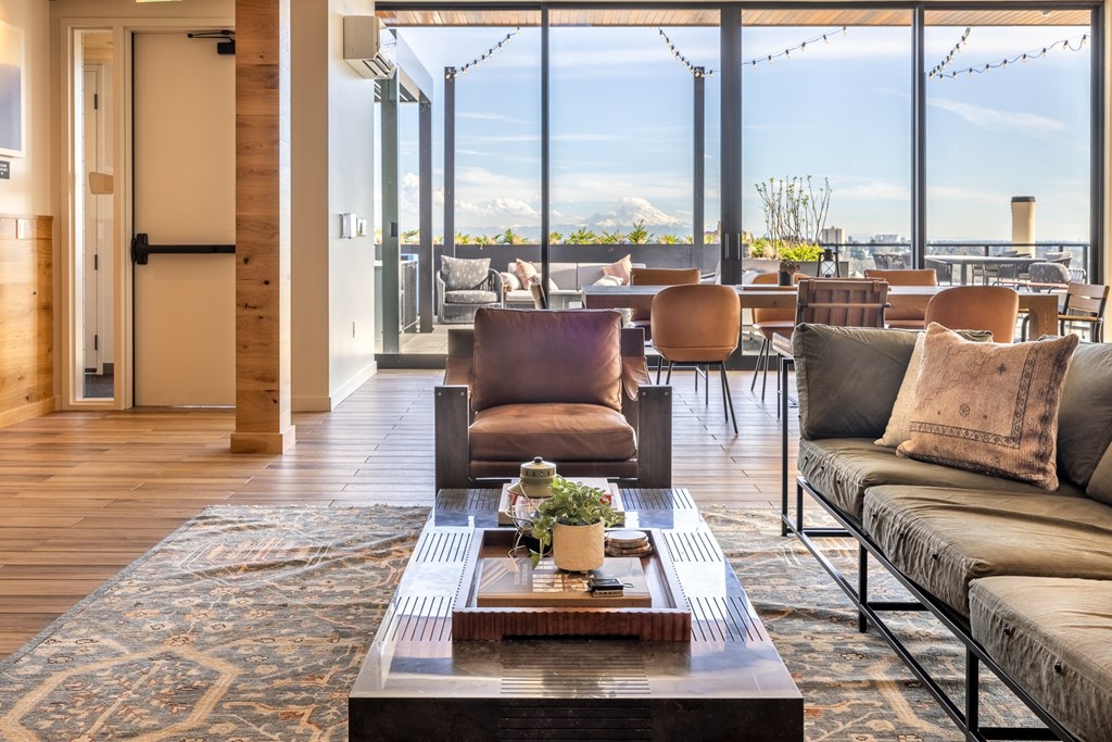 A modern living room with a view of the mountains outside the large windows.