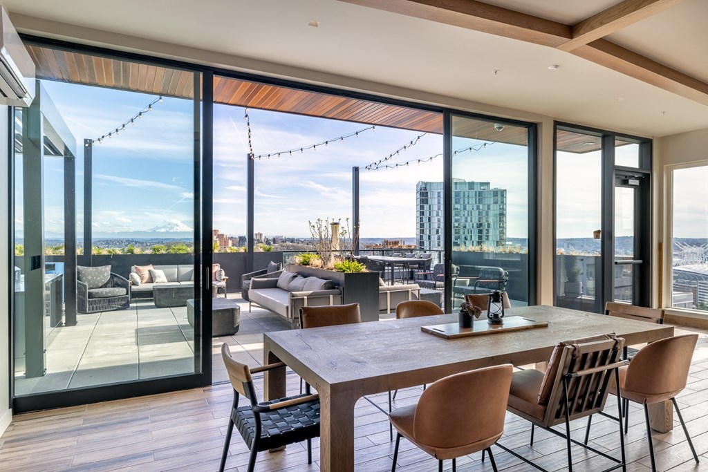 A modern dining room with a view of the cityscape.