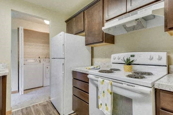 a kitchen with a stove and a refrigerator