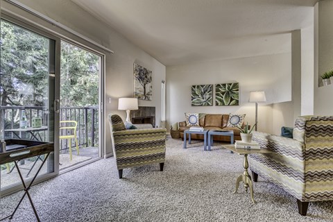 A living room with a striped couch and a yellow chair.
