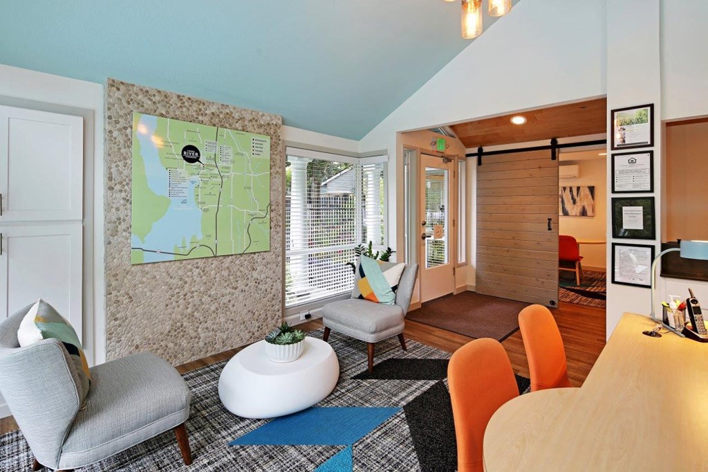 a living room with furniture and a map on the wall