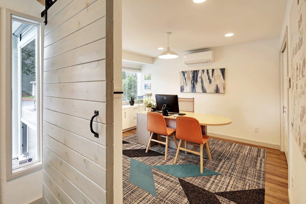 a dining room with a table and chairs and a computer