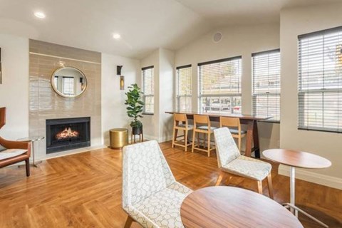 A living room with a fireplace and a chair.