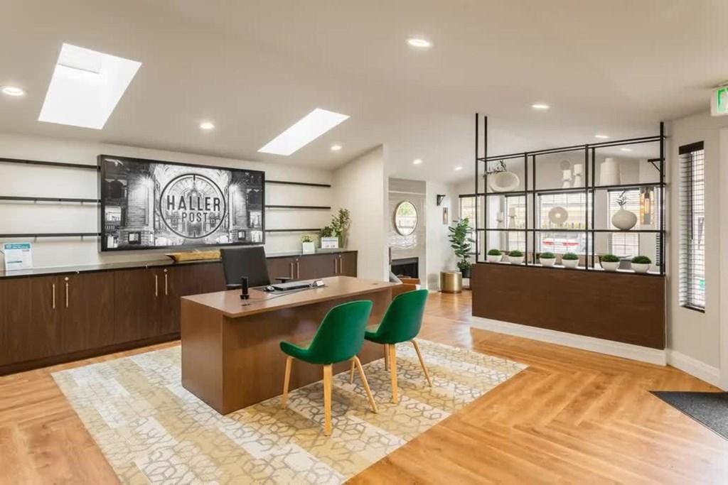 A reception area with a green chair and a brown desk.