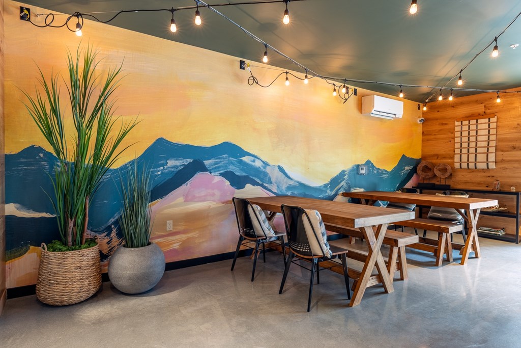 A room with a mural of a mountain landscape on the wall.