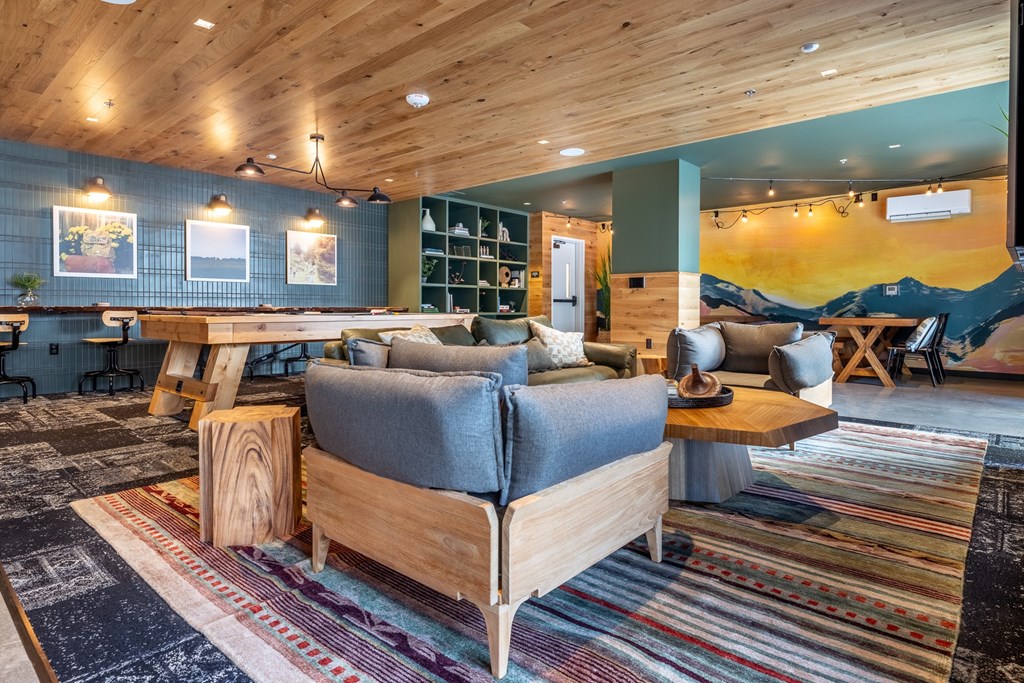 A living room with a grey couch and a wooden coffee table.