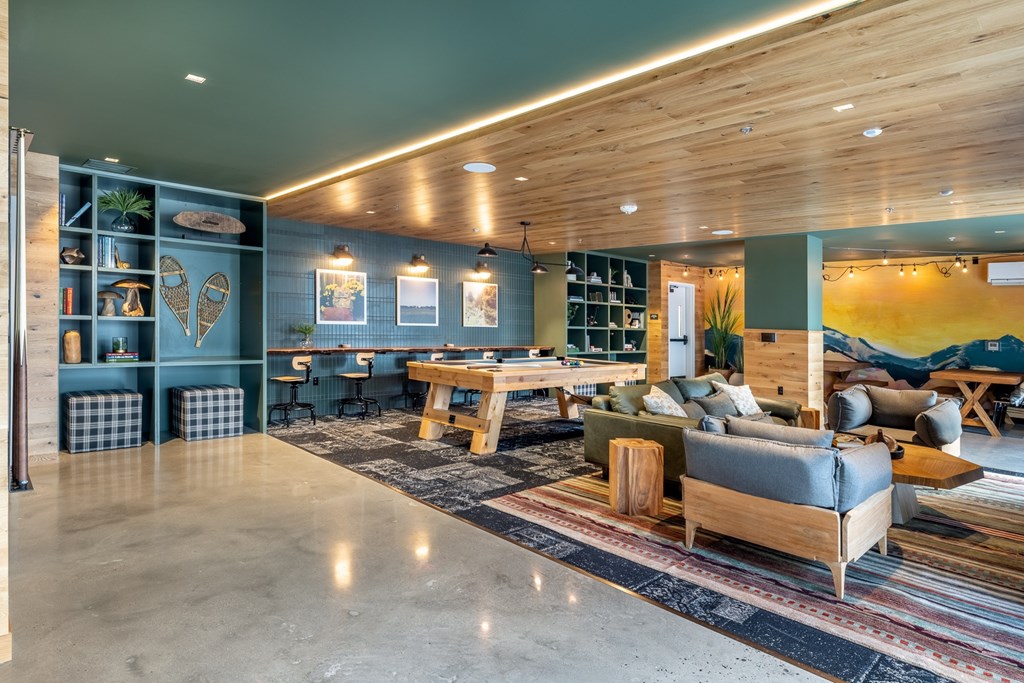 A modern living room with a wooden ceiling and a variety of furniture.