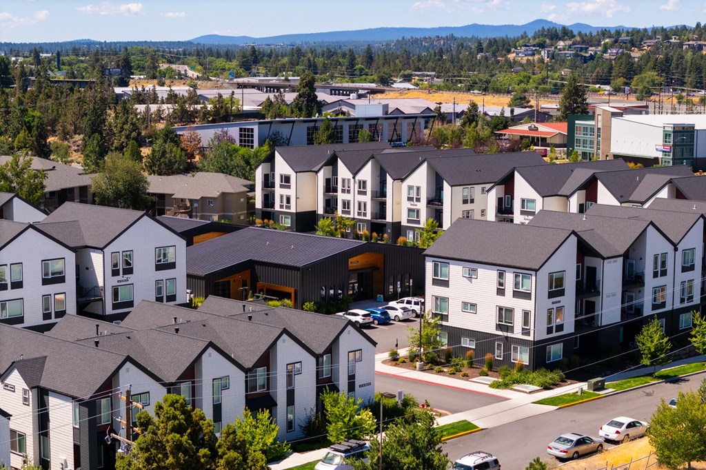 A large complex of houses with a mountain in the background.