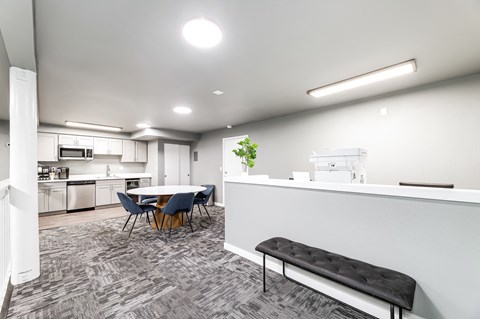 an open kitchen and dining room with a table and chairs
