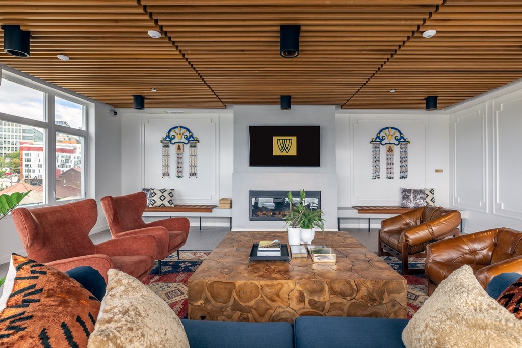 a living room with couches and chairs and a fireplace