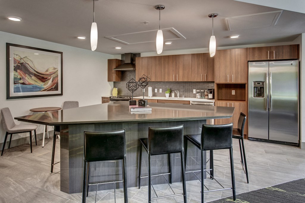 a kitchen with a large island with bar stools