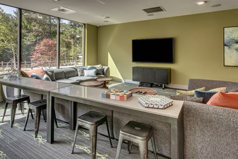 a living room with a long table and a television