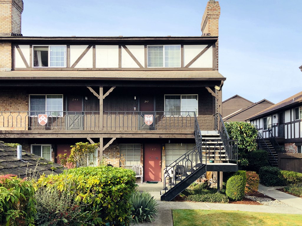 a large house with a balcony and a staircase