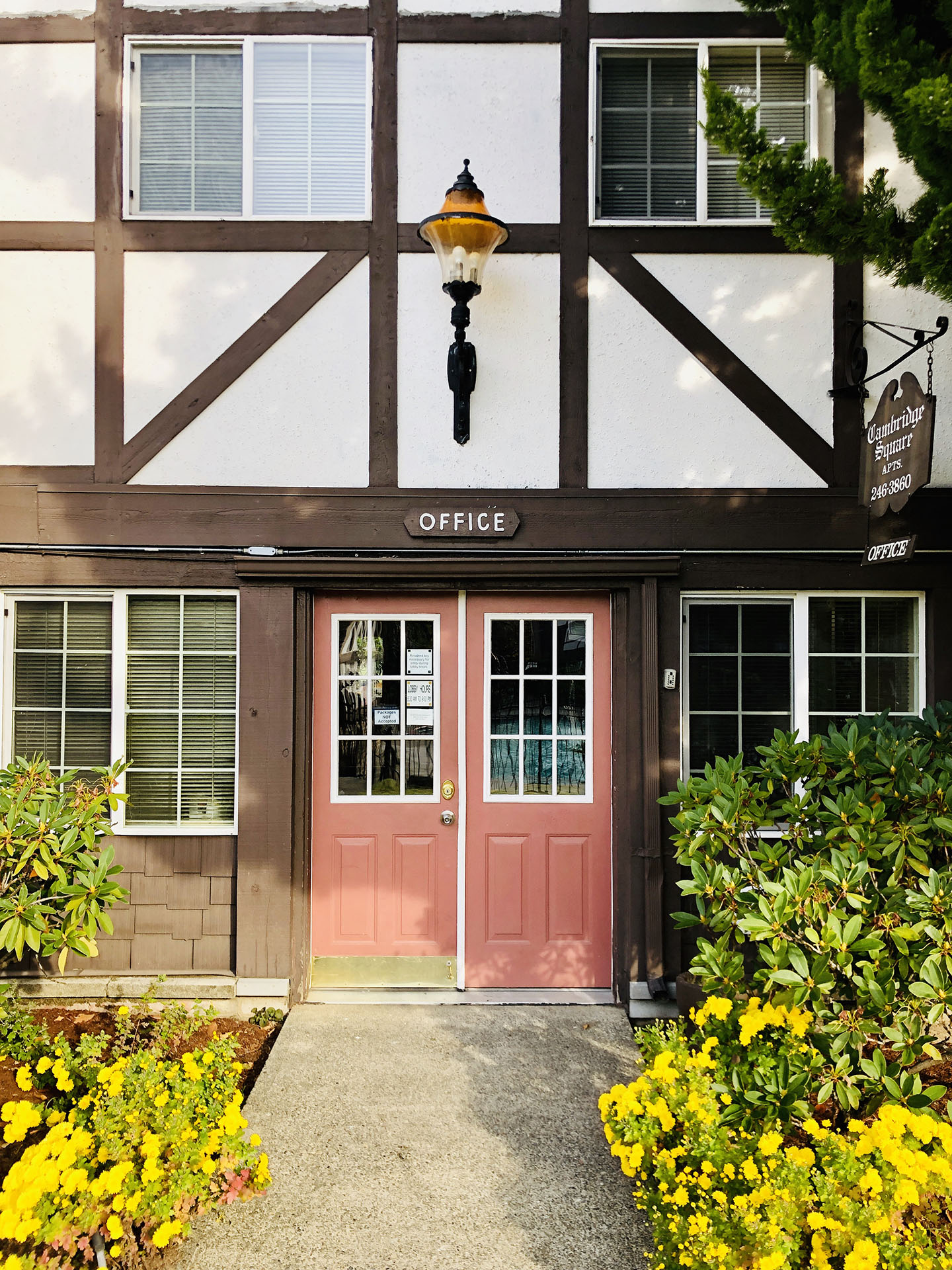 the entrance to the office building with pink doors
