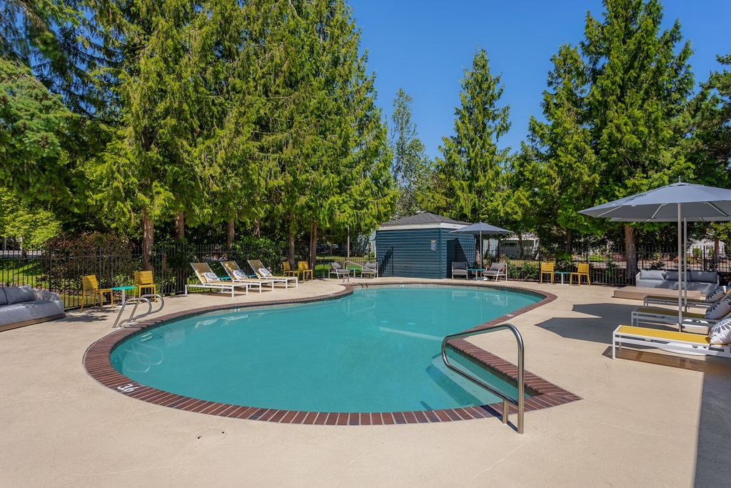 the resort style pool is surrounded by chairs and umbrellas