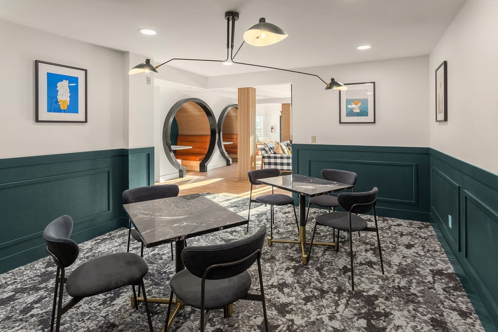 a dining room with tables and chairs and green walls
