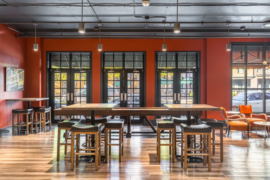 a large room with tables and chairs and windows