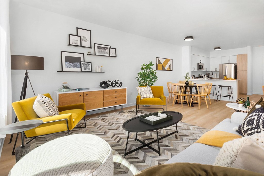 a living room with yellow chairs and a table
