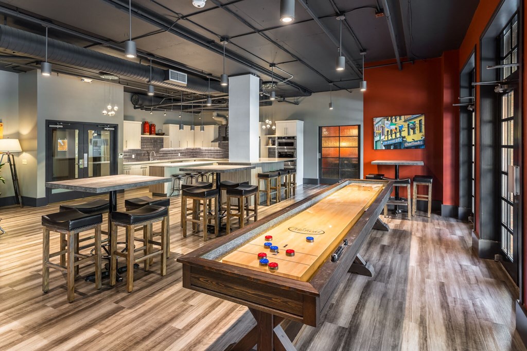 a game room with a pool table and a bar