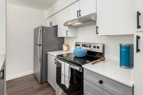 a kitchen with stainless steel appliances and white cabinets