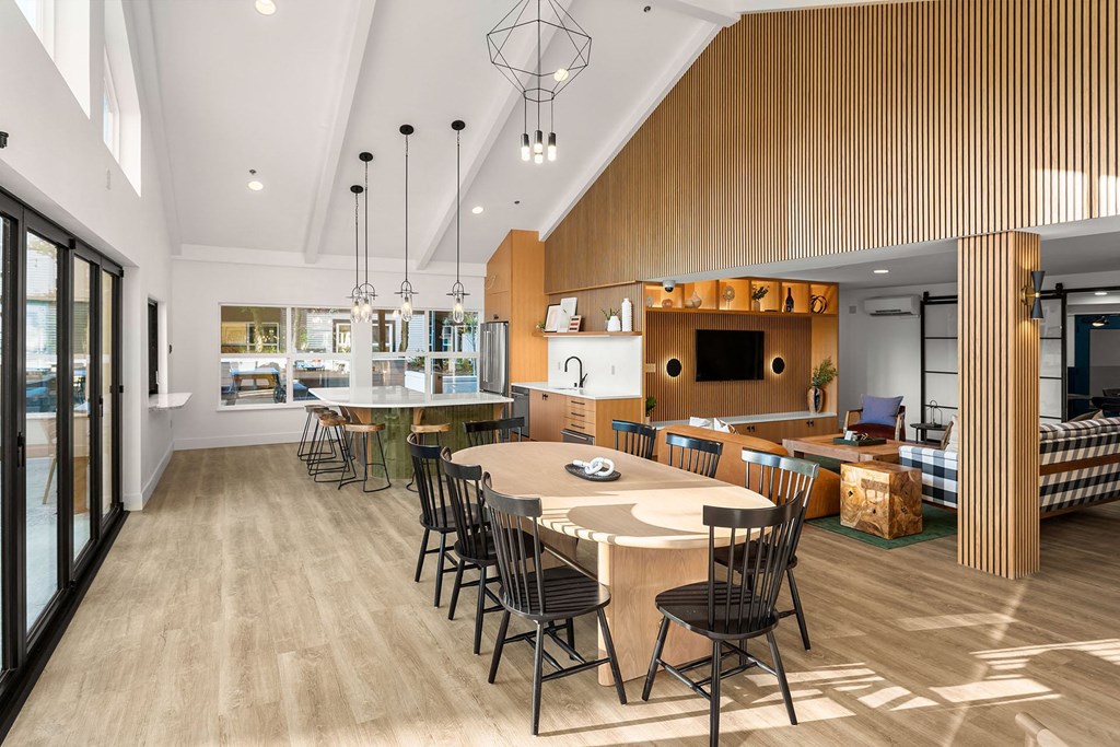 a dining room and kitchen with a table and chairs